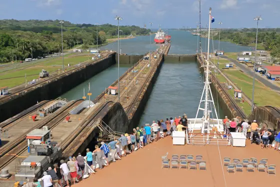 Visitors watching a ship transit the Panama Canal