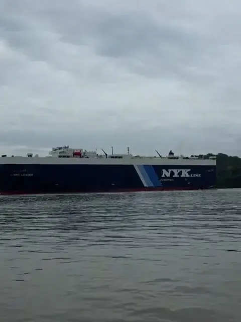 A cargo ship crosses Gatún Lake beside the boat
