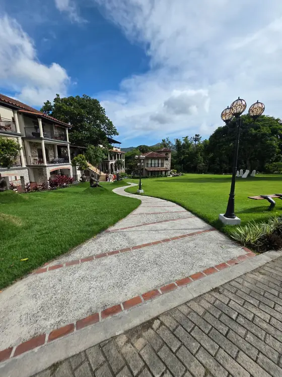 El Valle de Anton, Cocle, Panama: a paved garden path with the mountain behind